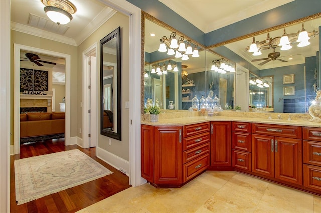 bathroom with vanity, crown molding, ceiling fan, and wood-type flooring