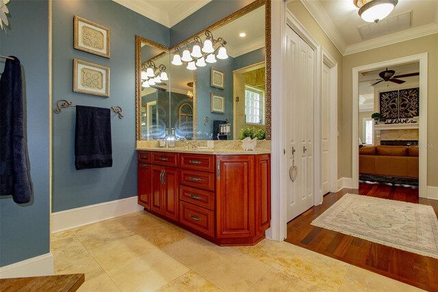 bathroom with ceiling fan, hardwood / wood-style floors, vanity, and ornamental molding