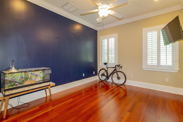 interior space featuring hardwood / wood-style floors, ornamental molding, and a wealth of natural light