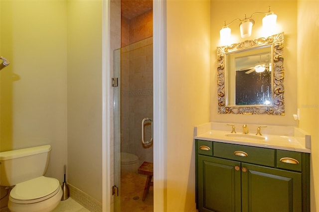 bathroom with tile patterned flooring, vanity, toilet, and walk in shower