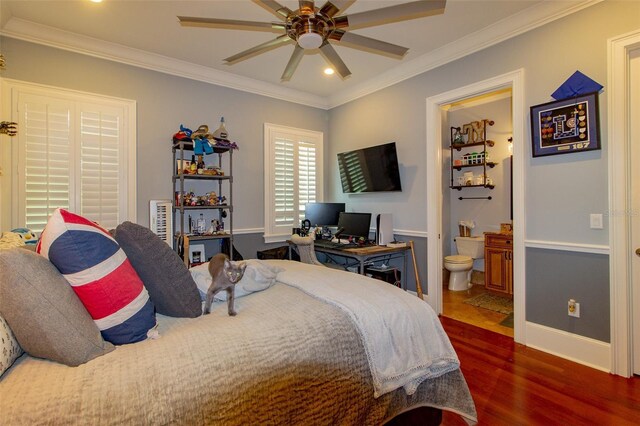 bedroom featuring dark hardwood / wood-style flooring, ceiling fan, crown molding, and connected bathroom