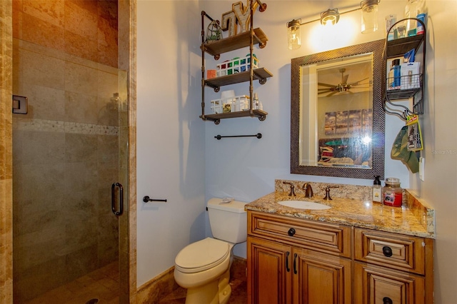 bathroom with vanity, toilet, and a shower with door