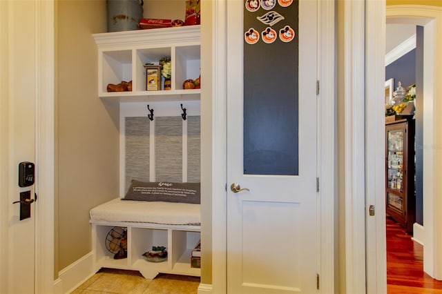 mudroom with crown molding and light hardwood / wood-style floors