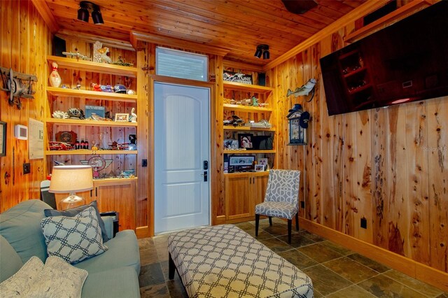 sitting room with wood walls and wood ceiling