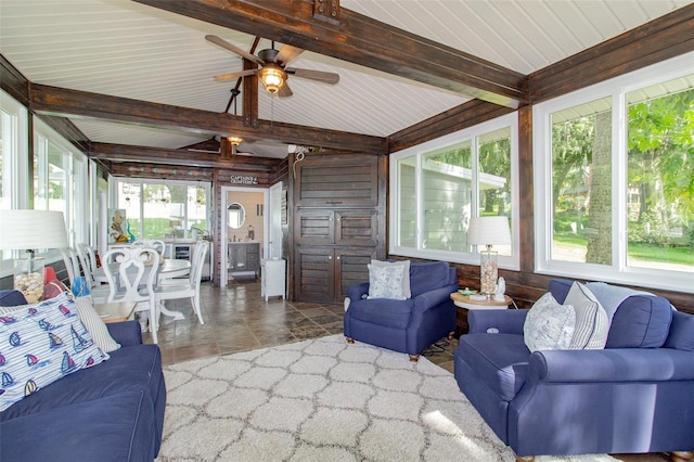 sunroom with ceiling fan and lofted ceiling with beams