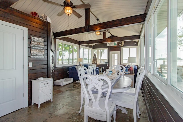 sunroom / solarium featuring vaulted ceiling with beams, ceiling fan, and a healthy amount of sunlight