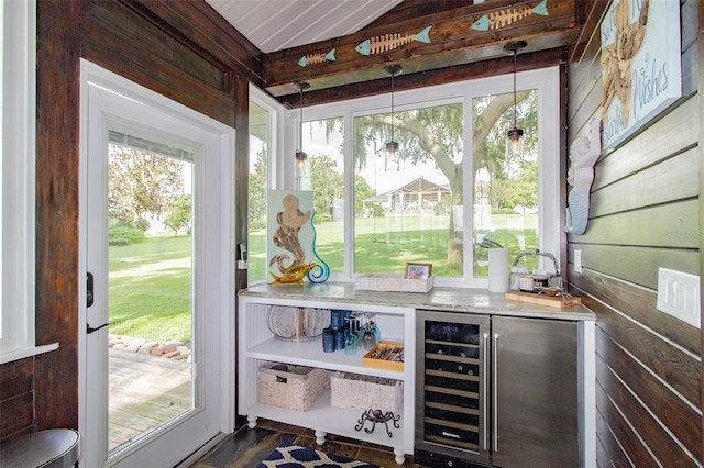 sunroom featuring wine cooler and bar area