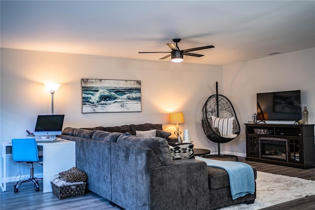 living room featuring ceiling fan and hardwood / wood-style floors