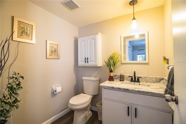 bathroom with vanity, wood-type flooring, and toilet