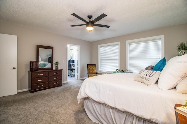 carpeted bedroom with ceiling fan and a textured ceiling