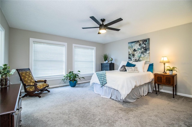 carpeted bedroom with a textured ceiling and ceiling fan