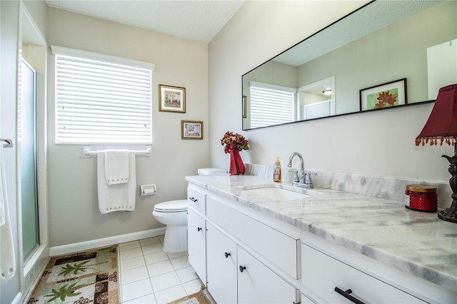 bathroom featuring tile patterned flooring, vanity, toilet, and an enclosed shower