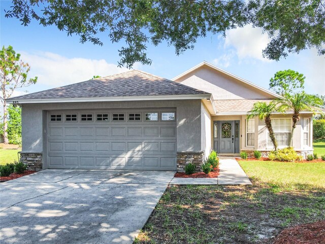 ranch-style home featuring a garage and a front lawn