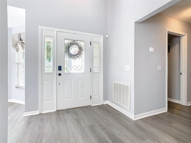 entryway with light wood-type flooring, baseboards, and visible vents