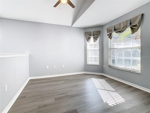 unfurnished room with a ceiling fan, lofted ceiling, baseboards, and wood finished floors