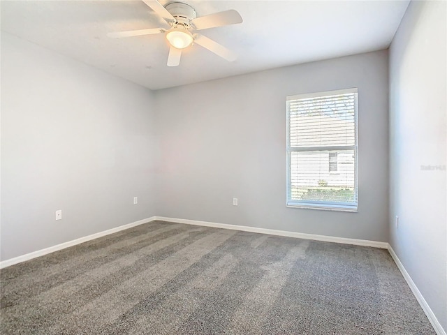 unfurnished room featuring carpet, a ceiling fan, and baseboards