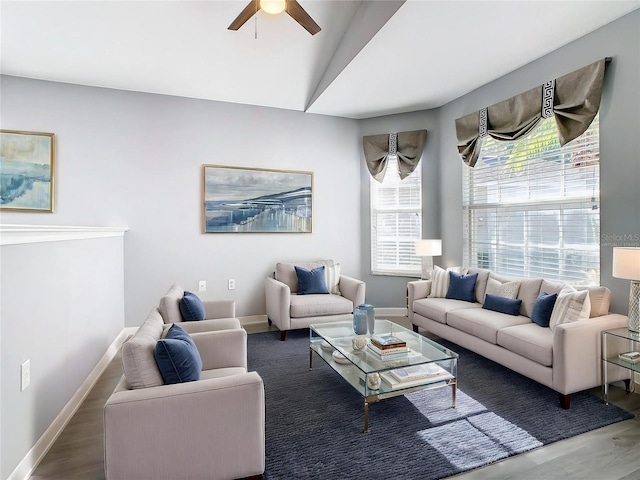 living room featuring ceiling fan, baseboards, wood finished floors, and lofted ceiling
