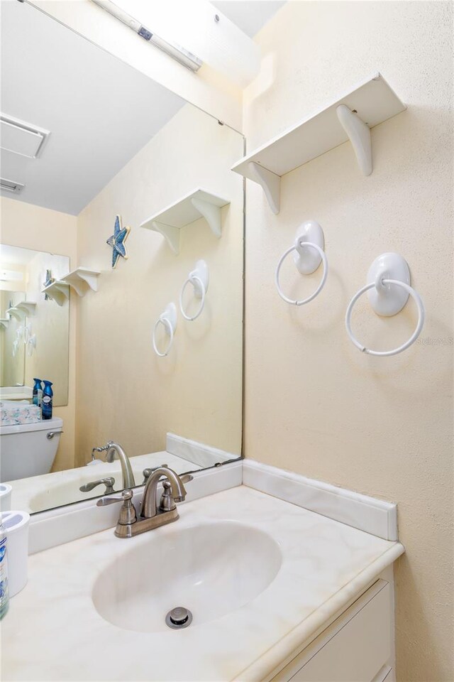 half bath featuring vanity and visible vents