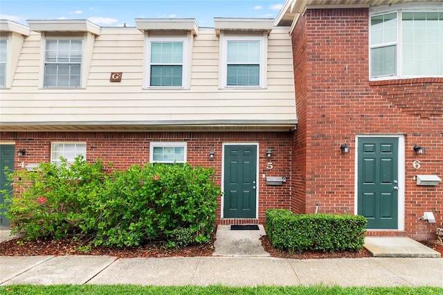 townhome / multi-family property with brick siding