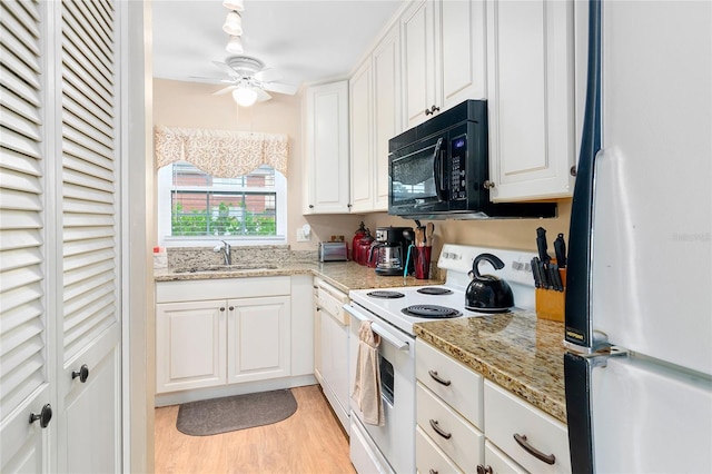 kitchen featuring light wood-style flooring, white appliances, a sink, a ceiling fan, and white cabinets