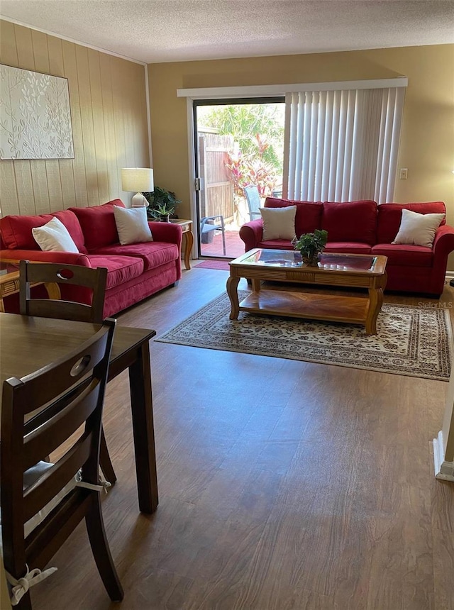 1920 E Edgewood Dr Unit G5, Lakeland, FL 33803 - living room featuring wood finished floors, a textured ceiling, and wooden walls