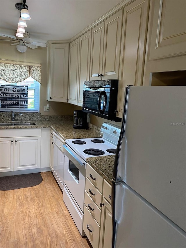 1920 E Edgewood Dr Unit G5, Lakeland, FL 33803 - kitchen with white appliances, ceiling fan, light wood finished floors, and dark stone countertops