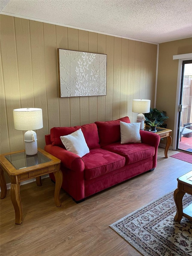 1920 E Edgewood Dr Unit G5, Lakeland, FL 33803 - living room featuring a textured ceiling, wood finished floors, and wood walls