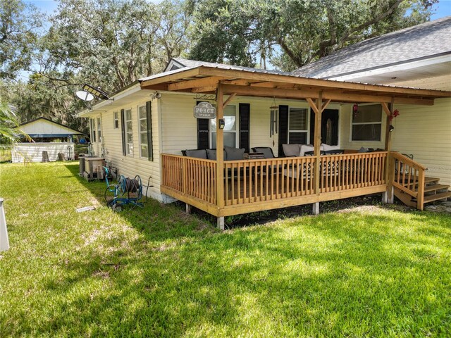 rear view of house with a yard