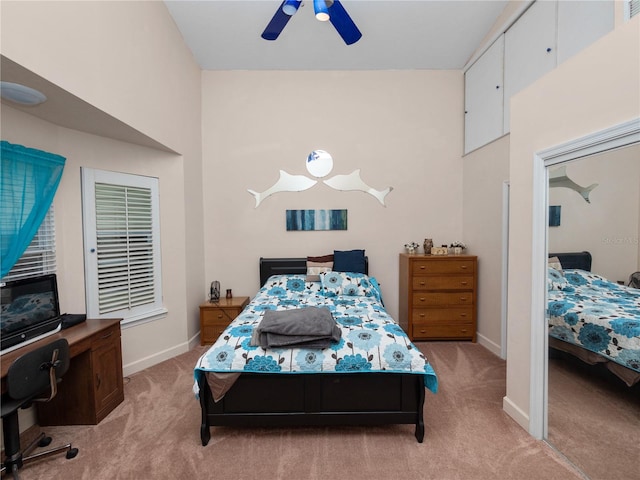 carpeted bedroom featuring a closet and ceiling fan