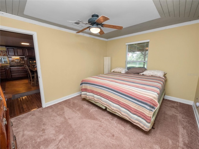 bedroom featuring ornamental molding, ceiling fan, and hardwood / wood-style flooring