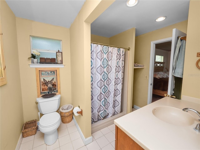 bathroom with tile patterned flooring, toilet, and vanity