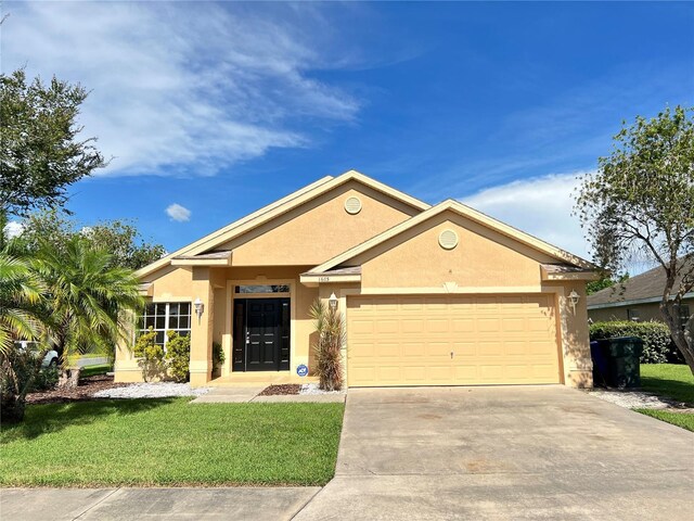 ranch-style home featuring a garage and a front lawn