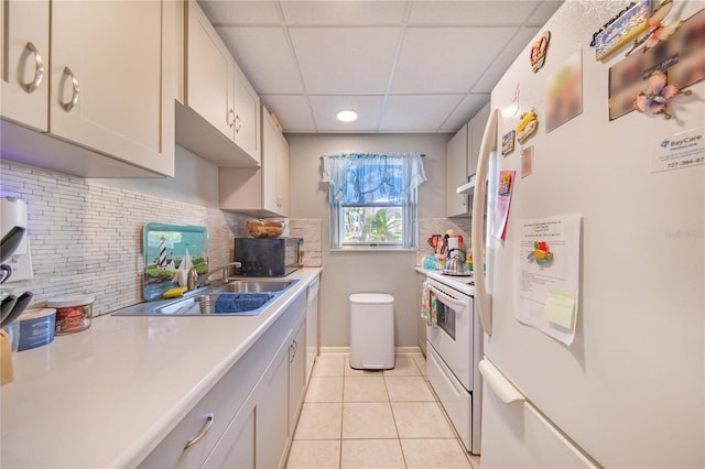 kitchen with sink, white appliances, light tile patterned floors, and decorative backsplash