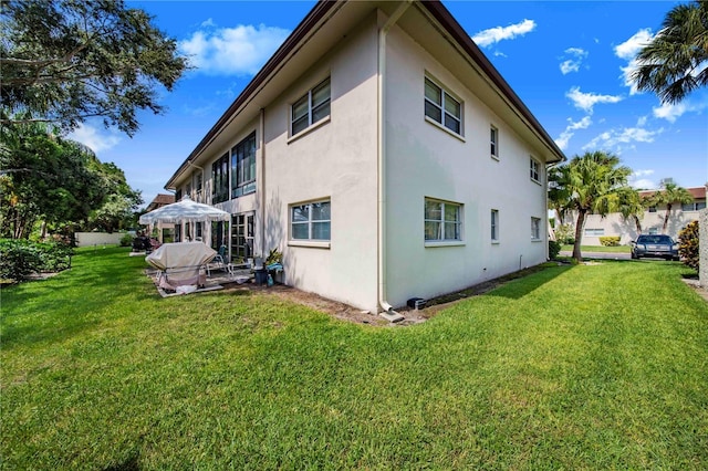 view of home's exterior with a lawn