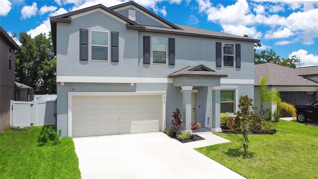 view of front of home with a front yard and a garage