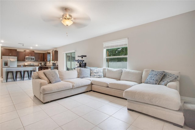 living room with ceiling fan and light tile patterned flooring