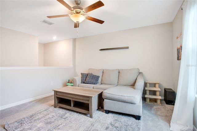 carpeted living room featuring ceiling fan