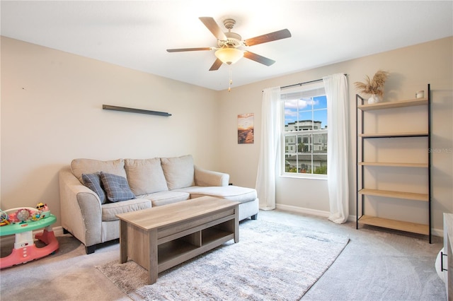 carpeted living room with ceiling fan