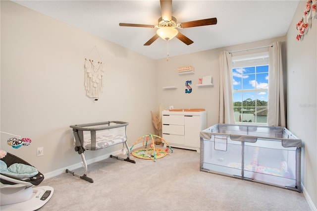 interior space featuring ceiling fan and light colored carpet