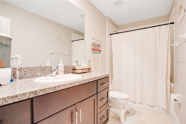 bathroom featuring vanity, toilet, and tile patterned flooring