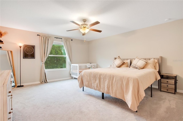 bedroom with ceiling fan and light colored carpet