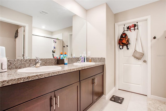 bathroom featuring tile patterned floors and double sink vanity