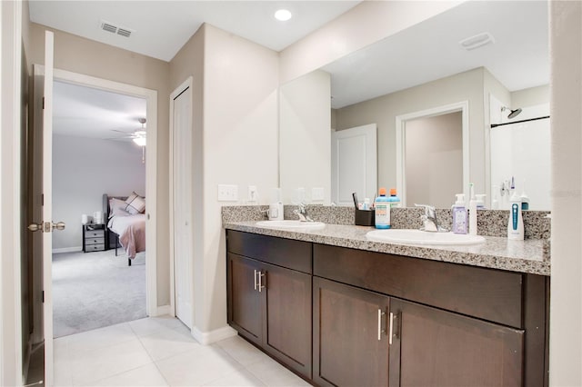 bathroom with ceiling fan, dual bowl vanity, and tile patterned floors