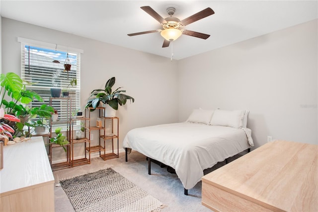 bedroom with ceiling fan and light colored carpet