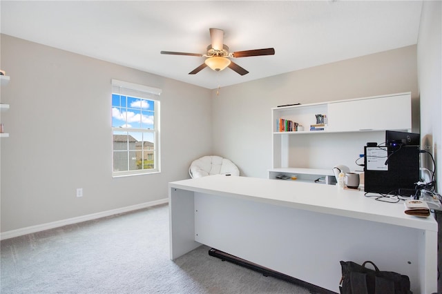 carpeted home office featuring ceiling fan