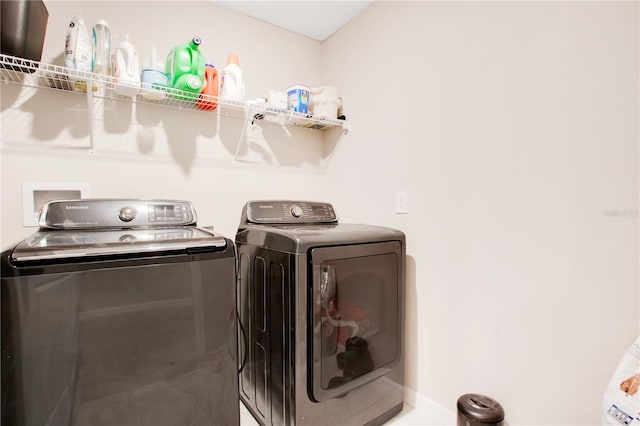 clothes washing area with independent washer and dryer