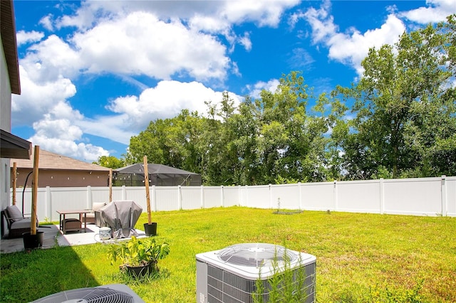 view of yard featuring central AC, a patio area, and an outdoor living space