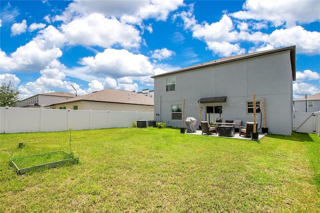 back of property with a patio and a yard