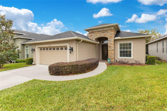 view of front facade with a front yard and a garage