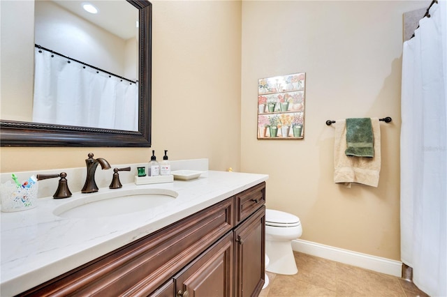 bathroom with tile patterned floors, vanity, and toilet